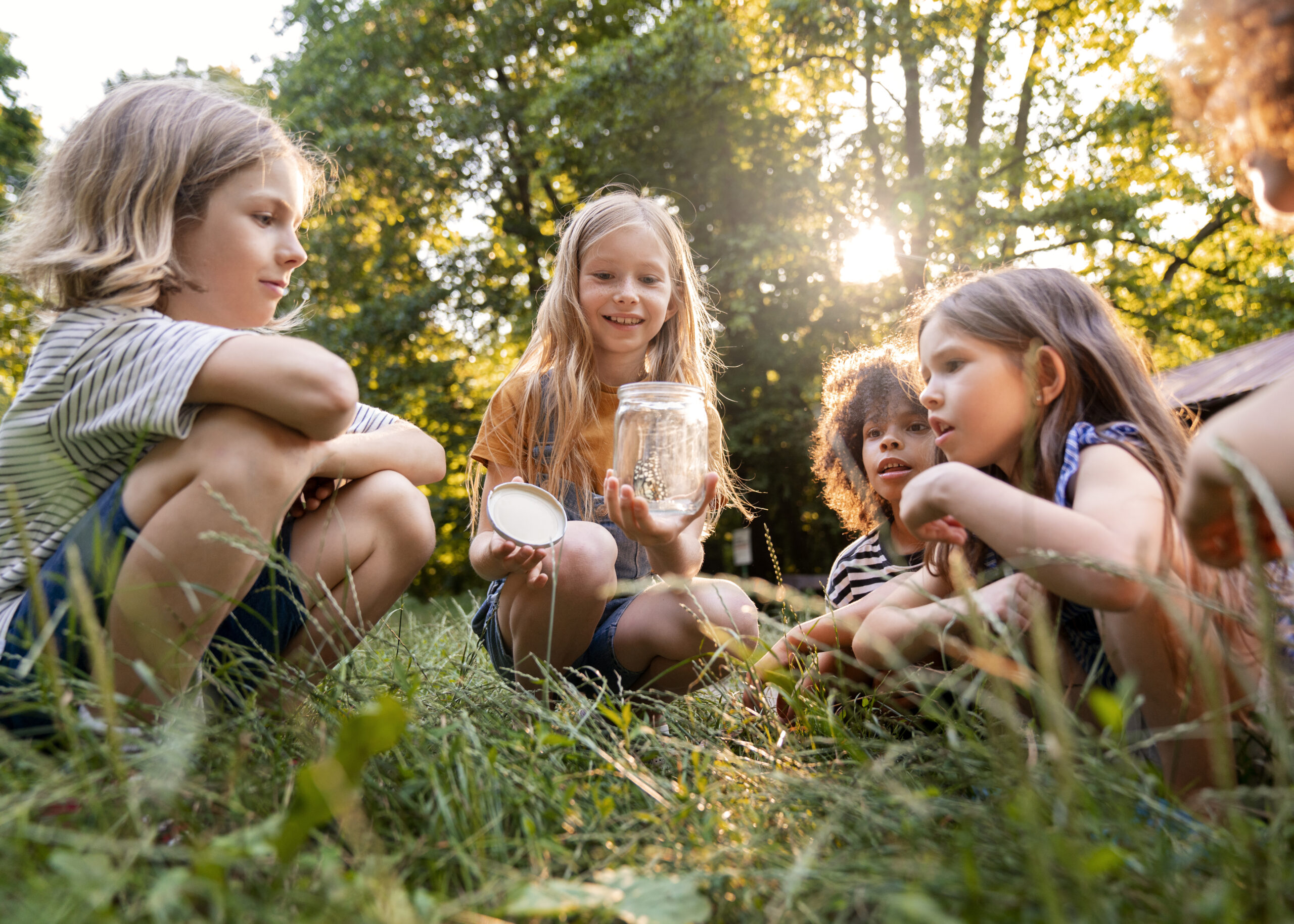 full shot kids sitting grass scaled